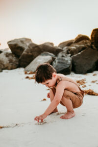 Family Photographer, a little boy plays in the sand